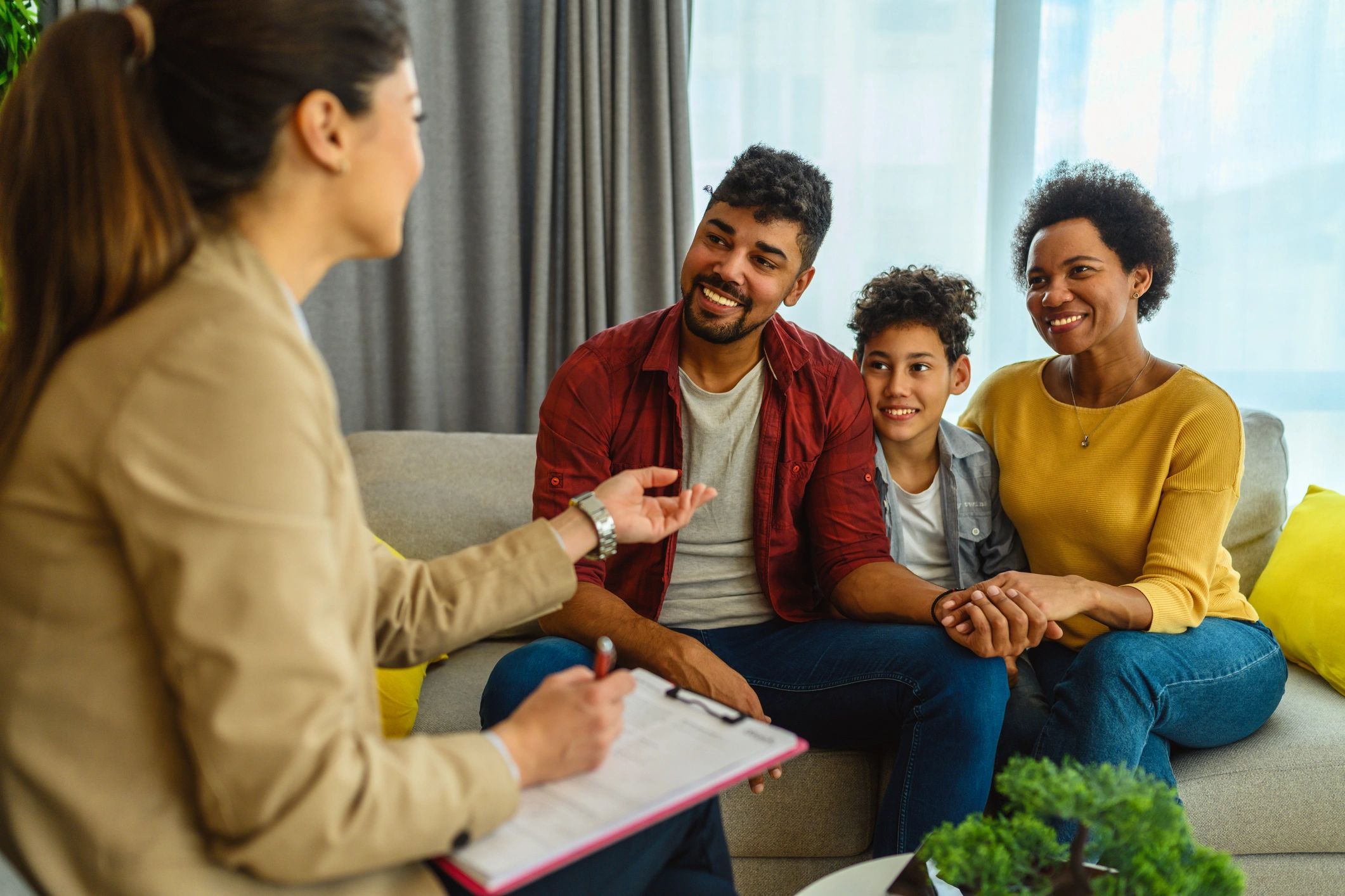 A family consulting a therapist in a cozy living room.
